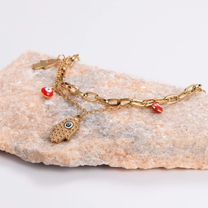 Golden double-layer bracelet featuring Hamsa Hand and Evil Eye charms on natural stone