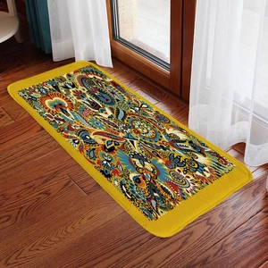 Detail view of rectangular paisley pattern flannel rug on brown wooden floor