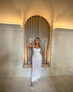 Detail of elegant white lace maxi dress with delicate straps and slim waist design