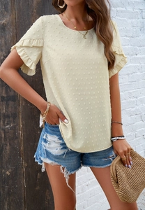 Close-up of pale yellow crewneck top with textured Swiss dots and ruffle sleeve details