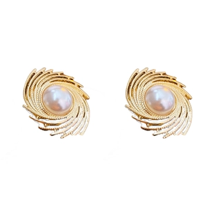 Vintage irregular gold swirl earrings with central pearl on a clean white background