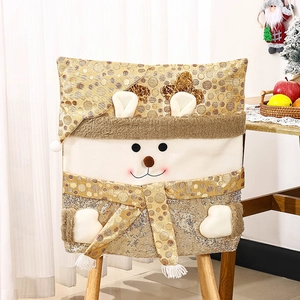 Detail of Christmas chair cover with gold sequins and 3D reindeer antlers on a dining chair