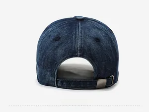Detail of adjustable metal buckle and denim strap on washed navy blue baseball cap