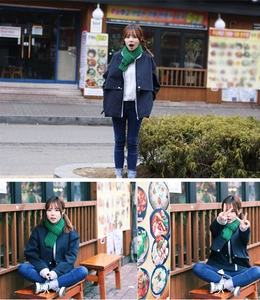 Detail of a dark blue casual zip-up jacket paired with a green knit scarf for children
