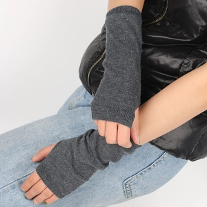 Close-up of long dark grey knitted fingerless arm sleeves with elastic texture detail