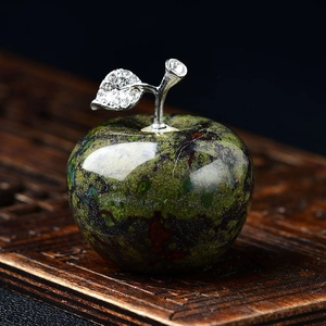 Macro shot of dark green crystal apple decor with silver stem and crystal leaf detail