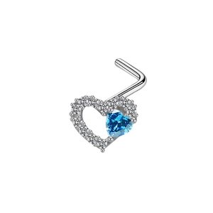 Macro shot of silver heart nose stud with blue opal and small sparkling zircon stones