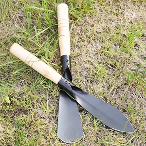 Garden tool set with pointed and flat manganese steel shovels on natural grass background