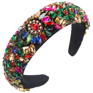 Detailed shot of luxury velvet headband with colorful rhinestones and pearl flower center