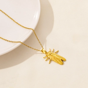 Close-up of golden cicada insect pendant with detailed wings on fine O-chain necklace