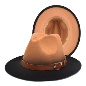 Detail of wool fedora with camel crown and black brim featuring brown leather band buckle