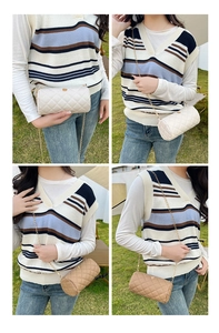 Outdoor lifestyle shot of white and brown quilted cylinder bags with chain straps