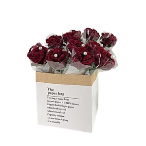 Handmade burgundy chenille stem rose bouquet in a white eco-friendly paper gift bag