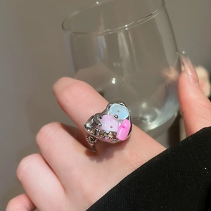Detailed view of silver heart ring with pastel shell stones and sparkling zircons