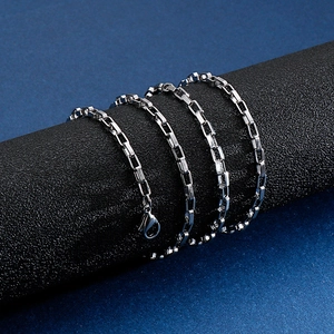 Polished silver stainless steel box chain necklace with lobster clasp on display stand