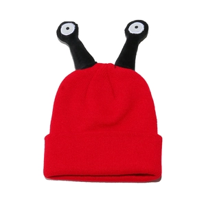 Detail of red knit beanie with funny 3D snail antennas and embroidered eyeball accents