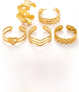 Detail view of 5-piece gold-plated titanium steel ring set with butterfly and heart textures
