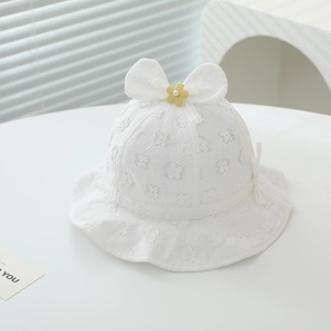 Detail of baby lace sun hat featuring white bow, yellow flower and wavy brim texture