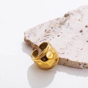 Macro shot of 18K gold plated stainless steel wide ring with unique hammered texture surface