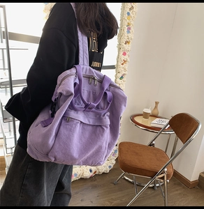Rear view of model wearing purple canvas backpack showing large capacity and adjustable straps