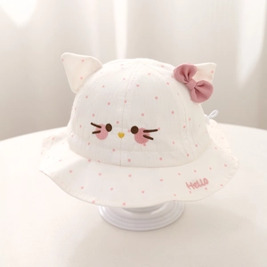 Detail of baby sun hat with pink polka dots, cat ears and Hello embroidery on white cotton