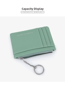 Detail view of light green cross-grain leather card holder with zipper pocket and key ring