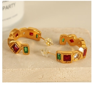 Macro shot of 18K gold plated studs featuring square red and green natural stones