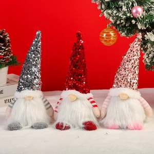 Detaillierte Aufnahme von drei festlichen Weihnachtsgnomen mit Pailletten in Rot und Silber.