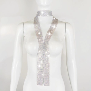 Close-up of sparkling silver rhinestone mesh scarf and necklace on a white mannequin