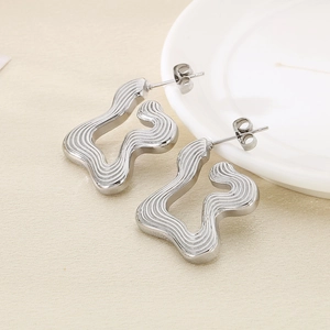 Minimalist silver irregular wave titanium steel stud earrings with textured finish