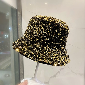 Fashionable bucket hat featuring shimmering gold sequins and minimalist modern style