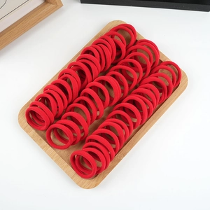50-piece set of high elasticity red seamless cotton hair bands on a wooden tray