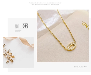 Close-up of gold chain necklace with marquise evil eye pendant pavé set with zircons