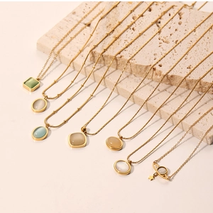 Detailed close-up of colorful cat-eye stone pendants on delicate gold beaded chains
