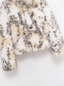 Detail of soft faux fur texture with animal print spots and ivory white plush fabric