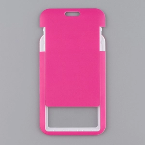 Macro detail of pink and white plastic ID card holder with lanyards hole on grey backdrop