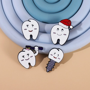Funny tooth enamel pin set with Christmas hat and toothbrush designs on blue pedestal