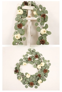 Detail of Christmas white pumpkin wreath with eucalyptus leaves, pine cones, and white berries