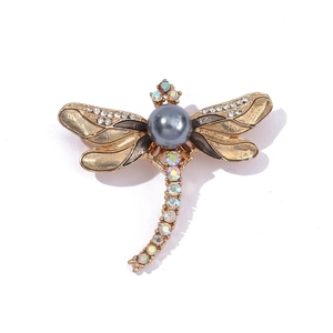 Detailed close-up of dragonfly brooch featuring gray pearl and colorful rhinestones