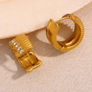 Detail of 18K gold plated textured hoop earring with inlaid cubic zirconia crystals