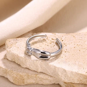 Detailed close-up of adjustable silver artistic ring featuring human body relief sculpture