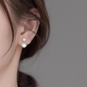 Elegant shell-shaped pearl earrings for women shown from a stylish side-wearing angle