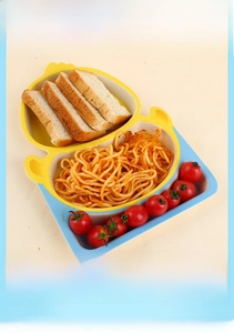 Detail of yellow duck bamboo fiber divided plate for kids with meal setup
