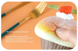 Macro shot of realistic PU foam cupcake magnet with red strawberry and cream topping