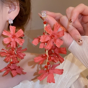 Elegant coral red fabric flower tassel earrings with crystal studs and gold accents