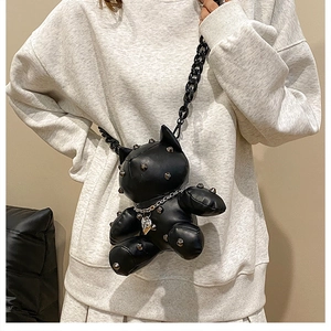Close-up of black punk bear crossbody bag with silver studs and thick plastic chain