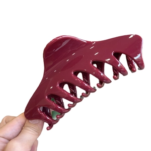 Glossy deep red 14cm minimalist hair claw clip held against a white background