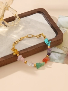 Close-up of bohemian gold link bracelet with colorful natural stone beads and lobster clasp
