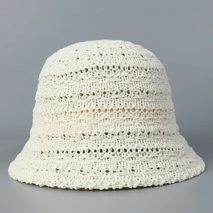 Detailed view of the hollow crochet knit texture on this cream summer bucket hat