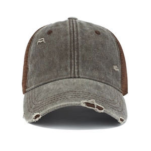 Close-up of distressed washed cotton baseball cap with breathable mesh and ripped details